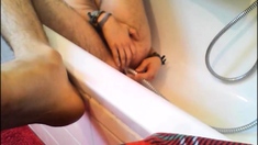 Bi-guy using shower head, squirting water, enema
